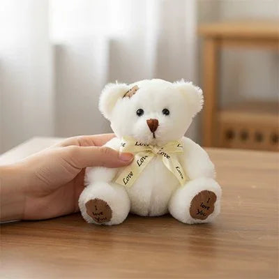 Ours peluche blanc 18 cm sur une table