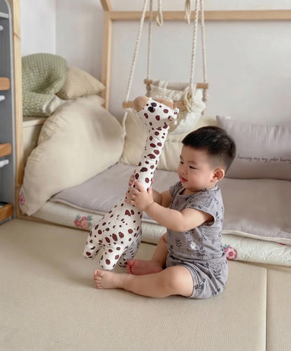 petit garcon qui caline sa peluche girafe