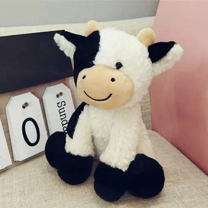 Peluche vache de 25 cm posé sur un meuble